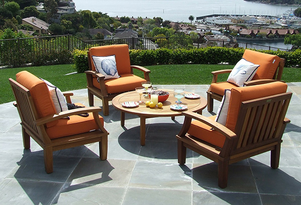 Outdoor seating area with deck furniture, backyard lounge setup, and scenic view.