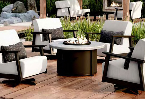 Outdoor swivel chairs with fire pit on wood patio deck